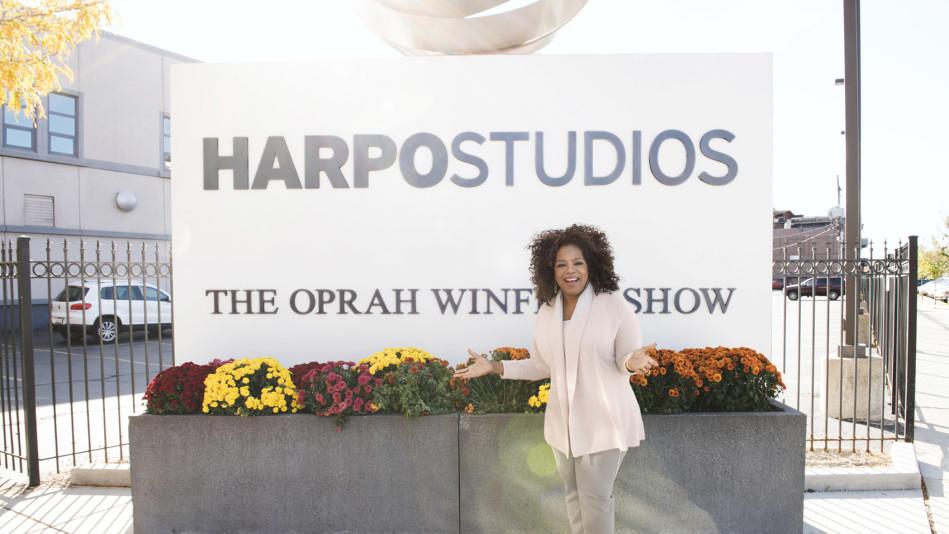Oprah Winfrey in front of Harpo Studios sign